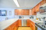 Newly renovated kitchen with bar seating and stainless appliances